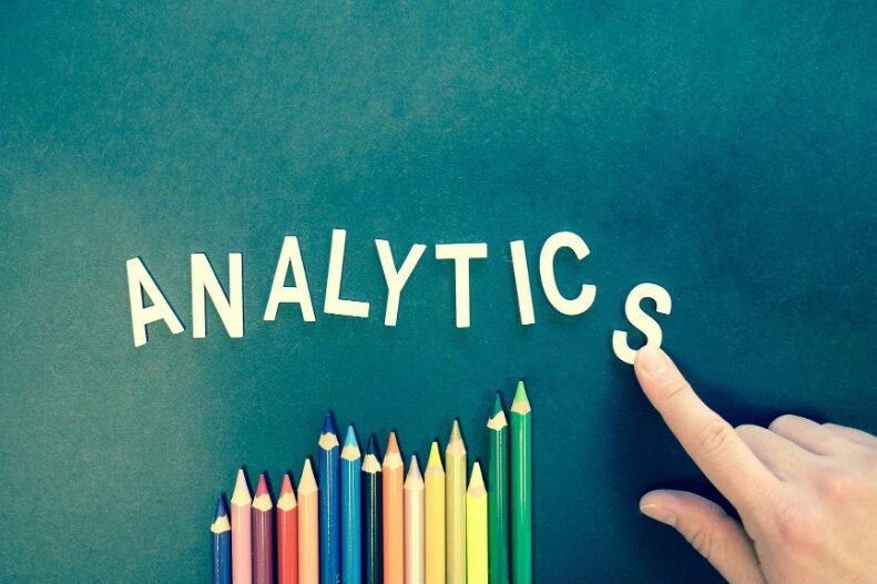 Business team analysing real-time data dashboards using cloud analytics tools.